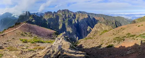 Ridges and paths below Pico do Arieiro’s viewpoint show the exposed mountain terrain ahead.